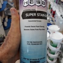Bottle of stain treatment held in a hand