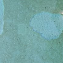 Pale blue pool surface with a lighter circular patch