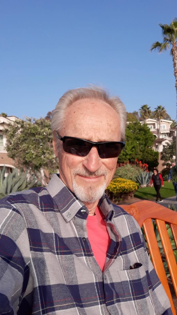 A man in sunglasses outdoors on a sunny day